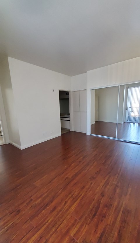 A room with wooden floors and white walls.