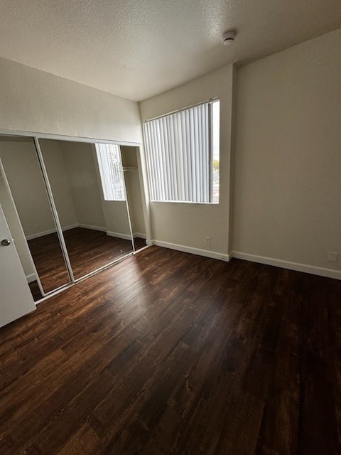 Empty room with wooden floors and white walls.