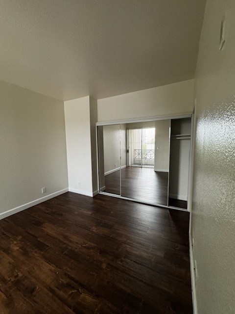 A room with wooden floors and a sliding glass door.