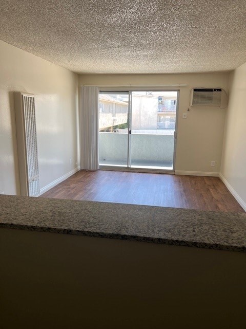A room with a carpeted floor and a sliding glass door.