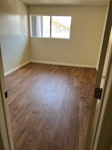 A room with wooden floors and a window.