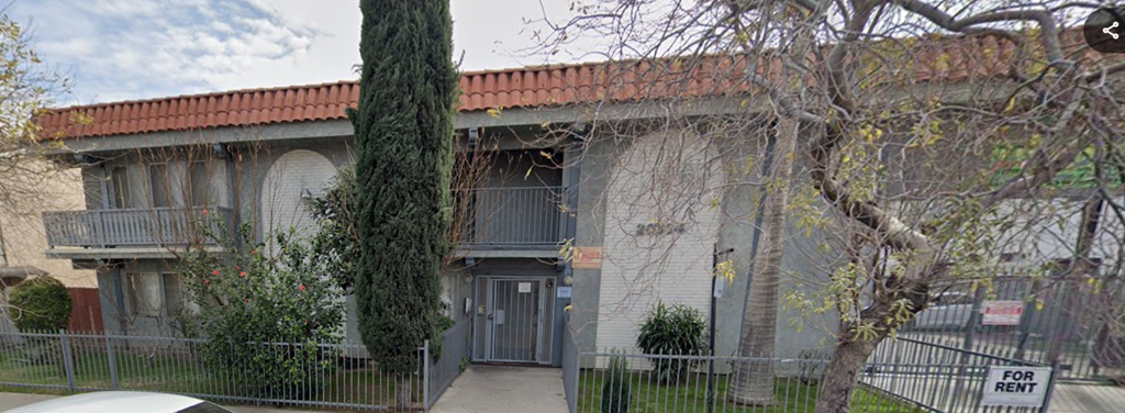 A building with a red tile roof and a balcony.