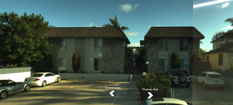 A house with a car parked in front of it.