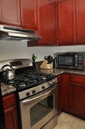 A kitchen with a stove and a microwave.