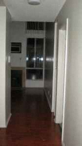 A long hallway with a door on the right.