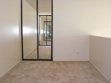 A room with a mirror on the wall.