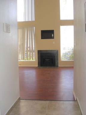 A living room with a fireplace and a television.