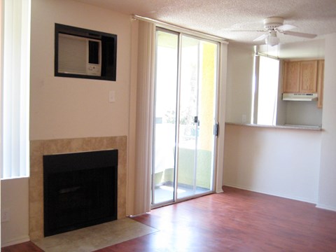 A living room with a fireplace and sliding glass doors.