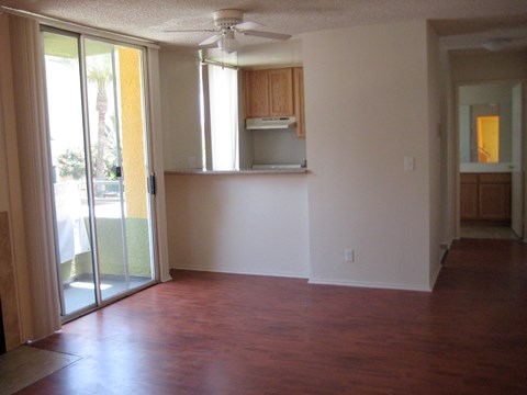 A room with a sliding glass door and a ceiling fan.