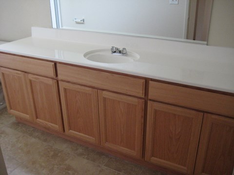A bathroom vanity with a sink and a mirror.