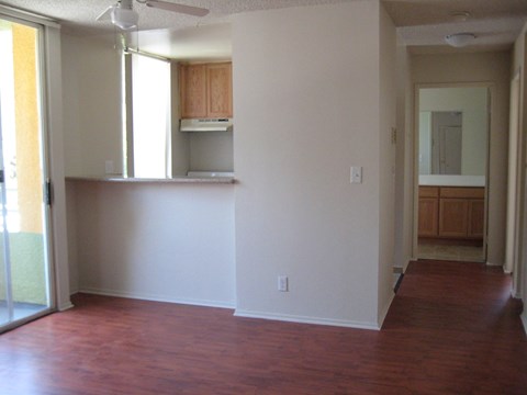 A room with a wood floor and white walls.