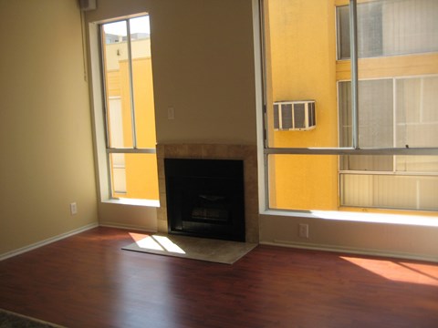 A room with a fireplace and a window.