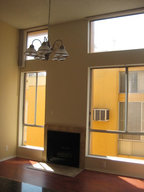A living room with a fireplace and a window.