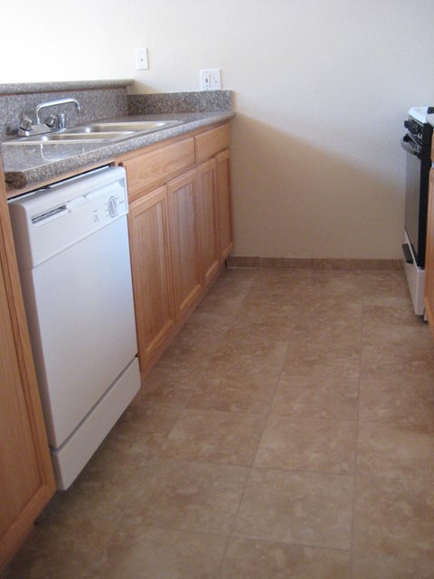 A kitchen with a washer and dryer in it.