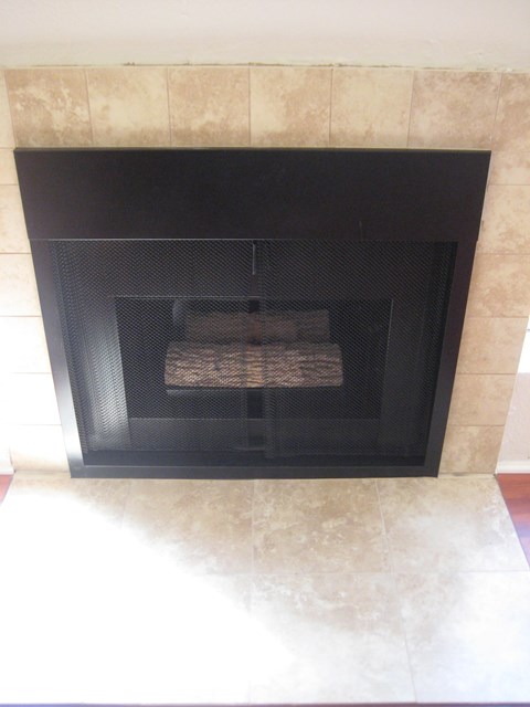 A fireplace with a fire burning inside.