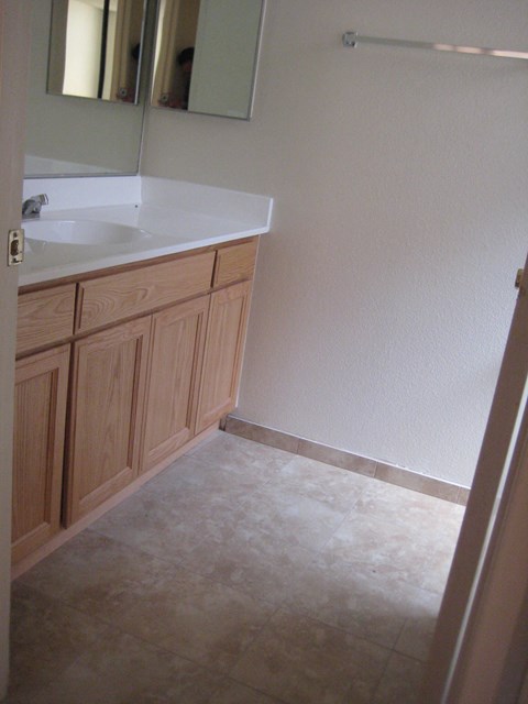 A bathroom with a sink and a mirror.