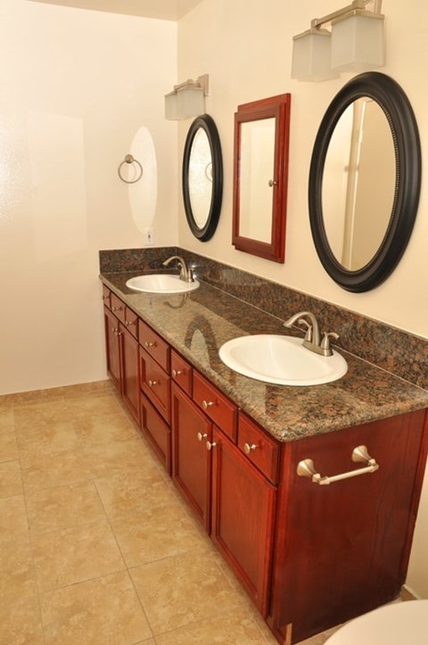 A bathroom with a sink and mirrors.
