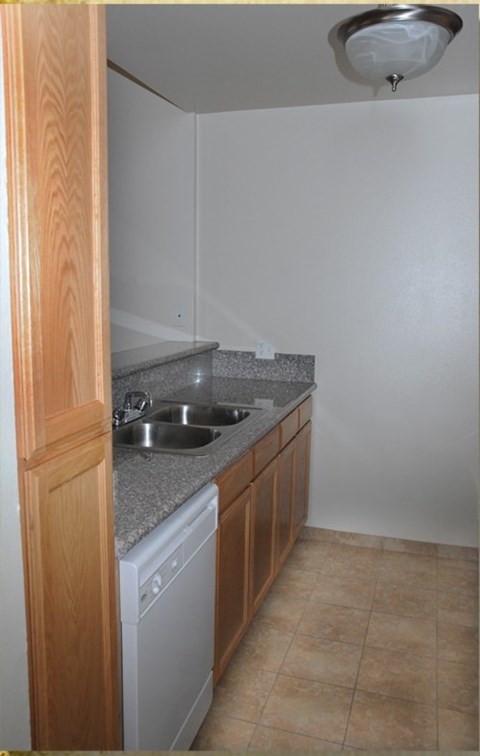 A kitchen with a washer and dryer built in.