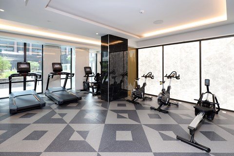 A gym with treadmills, exercise bikes, and elliptical machines.