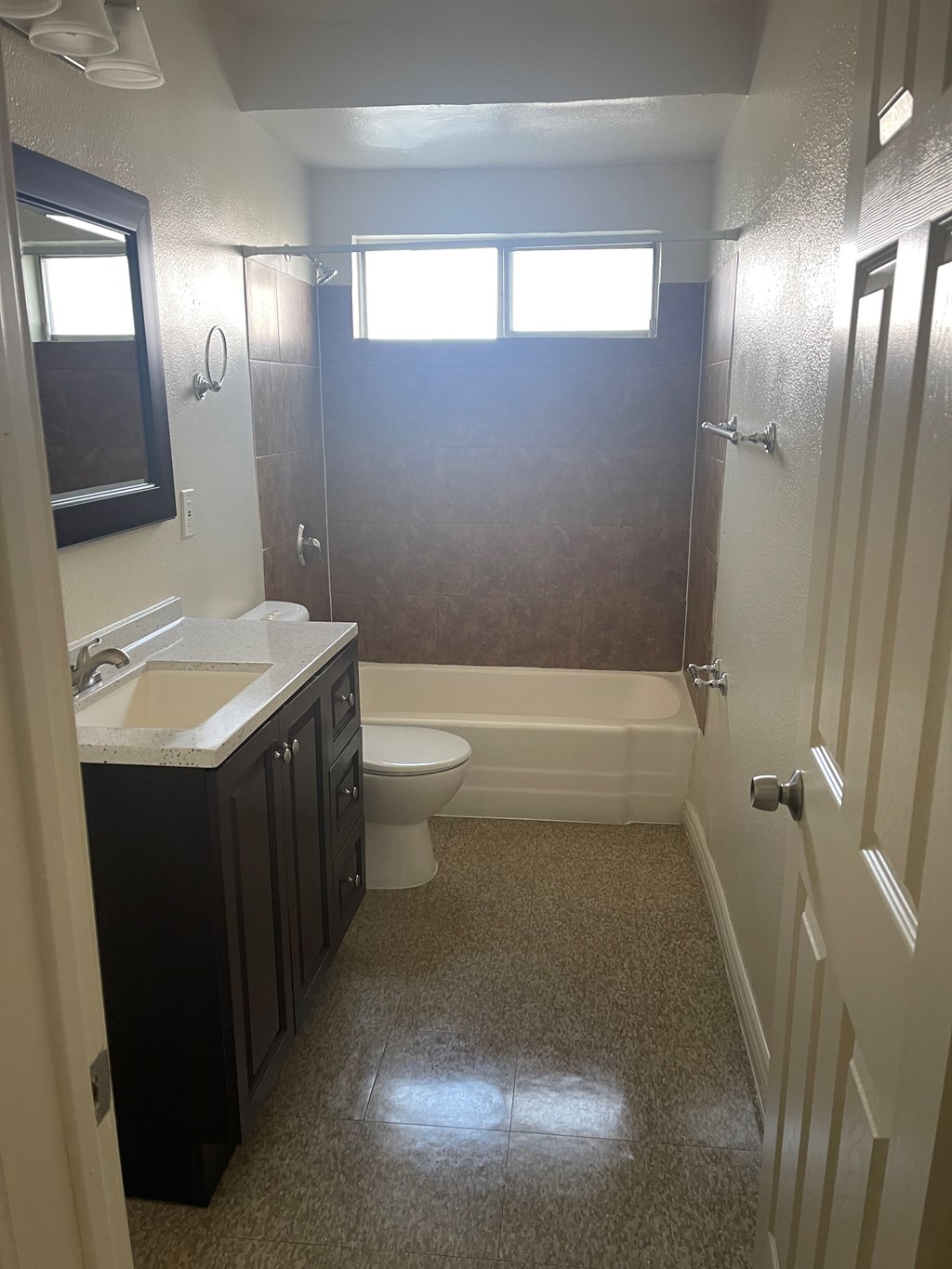 A bathroom with a toilet, sink, and bathtub.