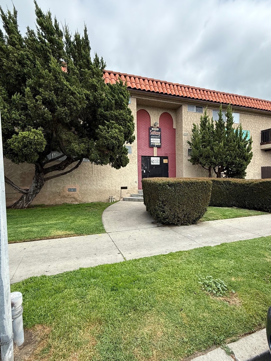 A building with a red roof and a sign on it.