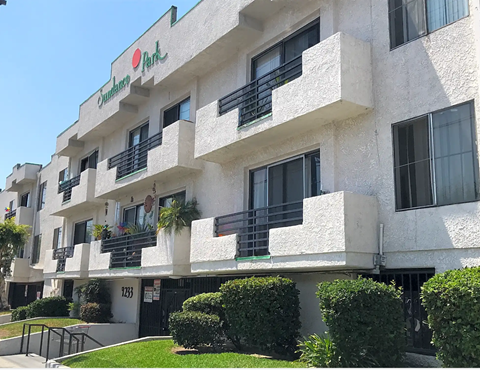 A white building with a red sign that says "Park".