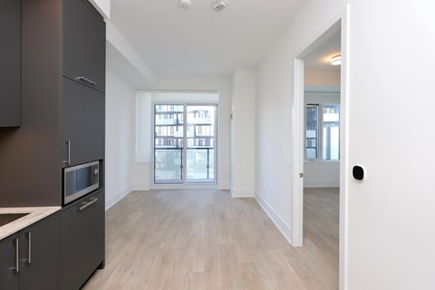 A kitchen with a microwave and a fridge.