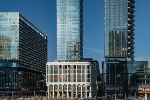 A cityscape with modern buildings and a clear blue sky.