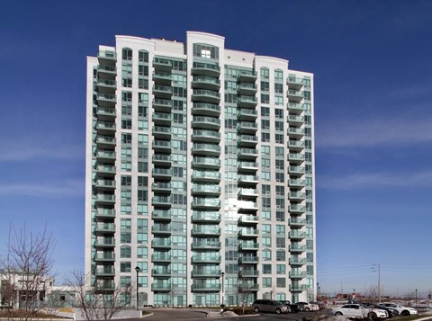 A tall residential building with many windows and balconies.