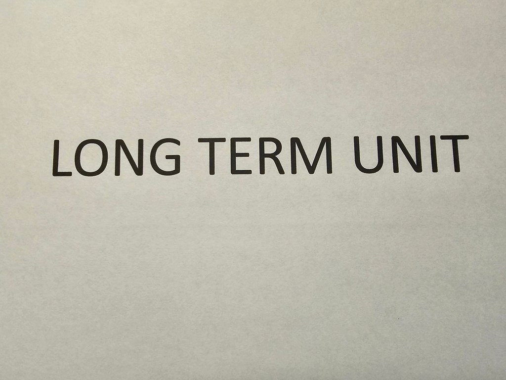 A piece of paper with the words "LONG TERM UNIT" printed on it.