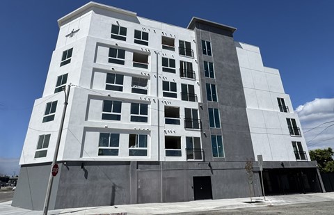 A modern building with a white facade and multiple windows.