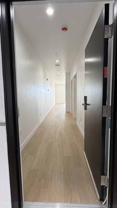 A long hallway with doors on both sides.