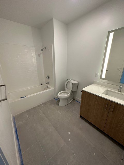A bathroom with a toilet, sink, and bathtub.