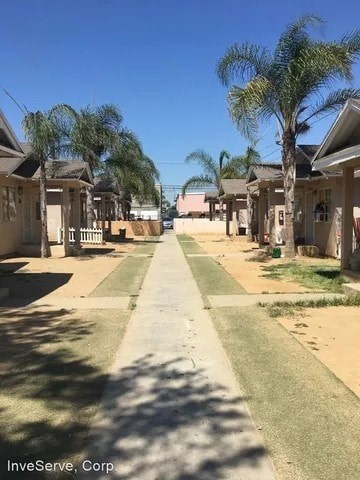 A sunny day at InveServe, Corp with a pathway leading to a building.