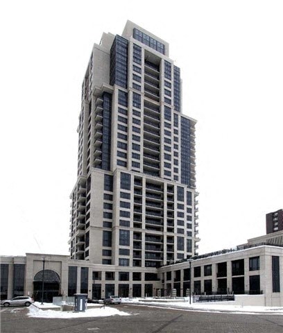 A tall building with many windows is in the background.
