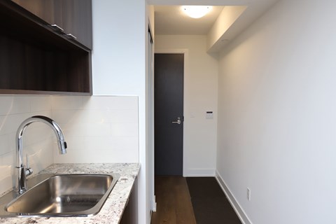 A kitchen with a sink and a door.