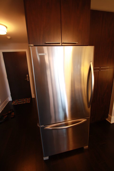 A stainless steel refrigerator in a kitchen.