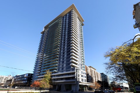 A tall building with a blue sky in the background.