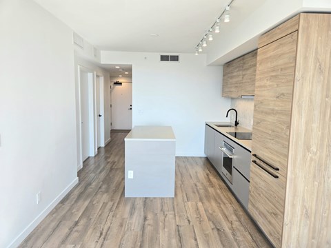 A kitchen with wooden cabinets and a white island.