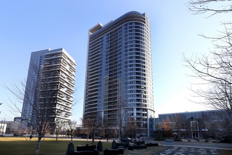 Two tall buildings with a clear blue sky in the background.