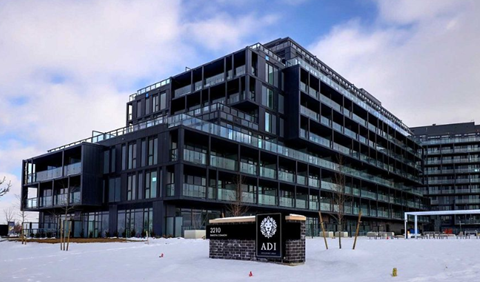 A large black building with a sign that reads "ADI" in front of it.
