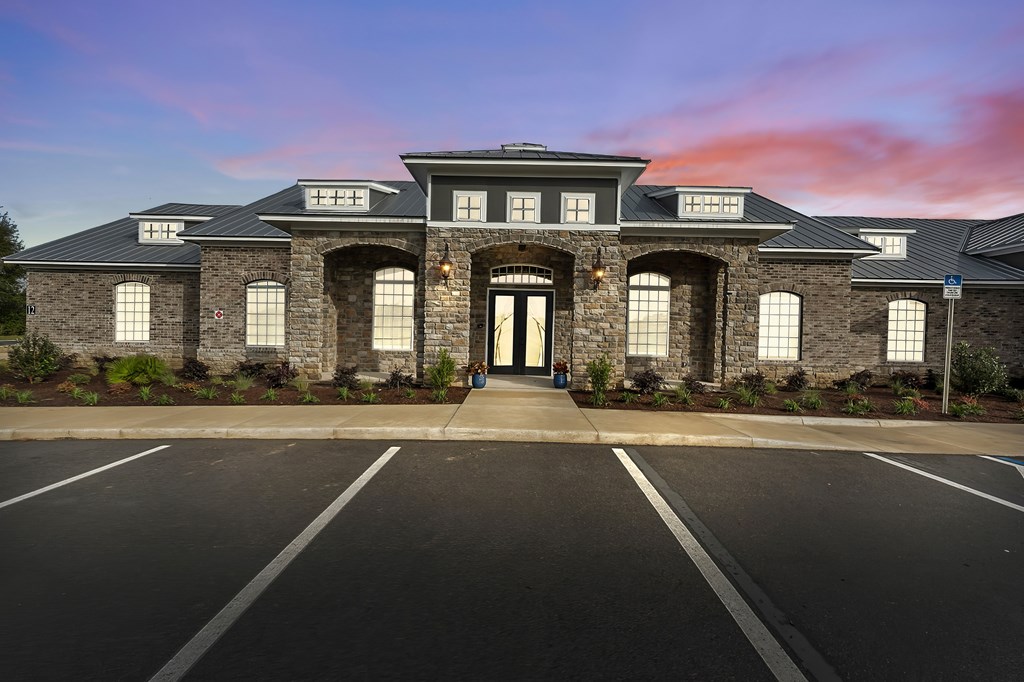 A large house with a black roof and stone walls.