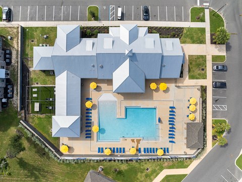 A modern building with a glass pool in front.
