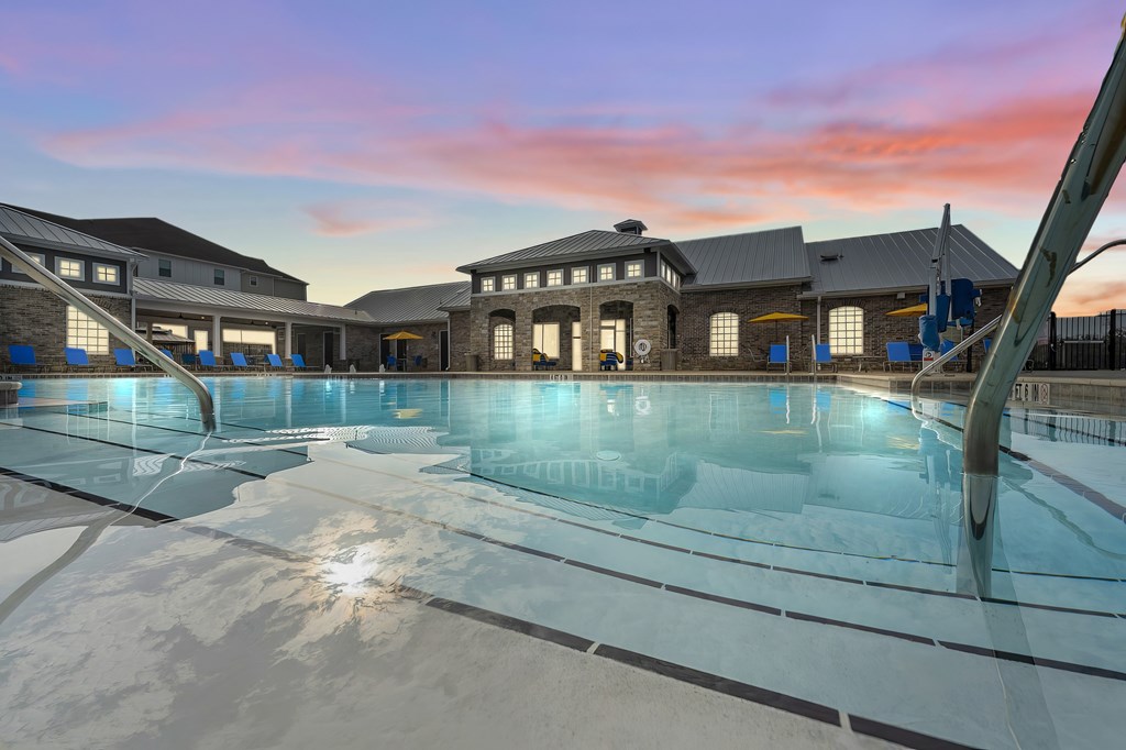 A modern building with a glass pool in front.