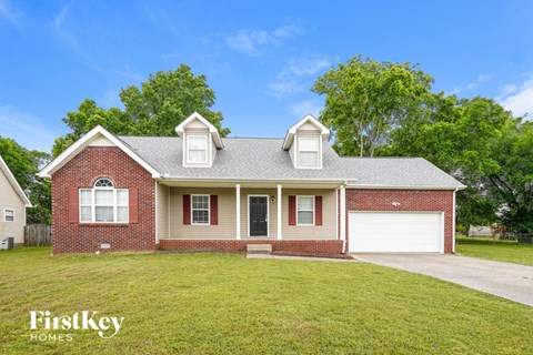 A house with a red brick exterior and a grey roof.