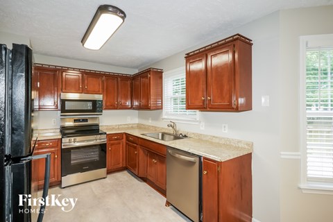 A kitchen with wooden cabinets and stainless steel appliances.