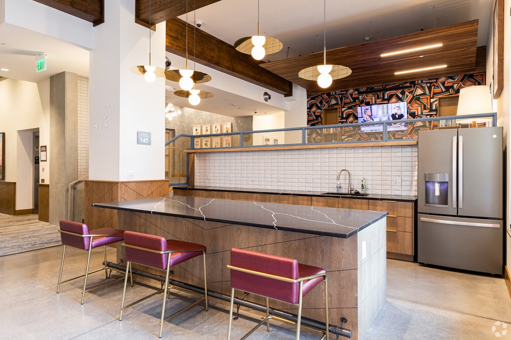 A kitchen with a bar area and two chairs.