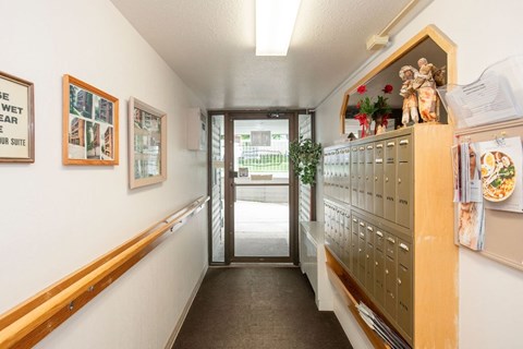 A hallway with a sign that says "Wet Floor Wear Shoe".