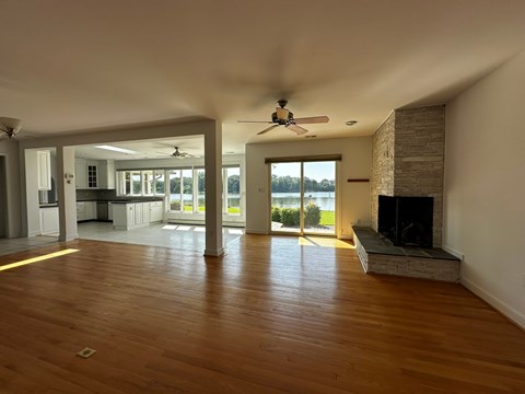 A spacious living room with a fireplace and sliding glass doors.