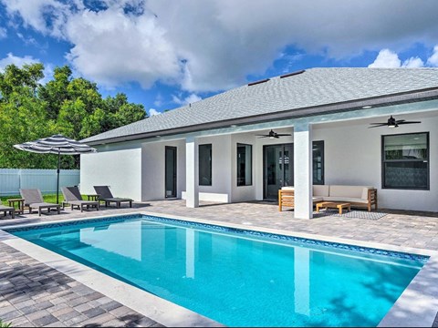 A modern house with a pool in the backyard.
